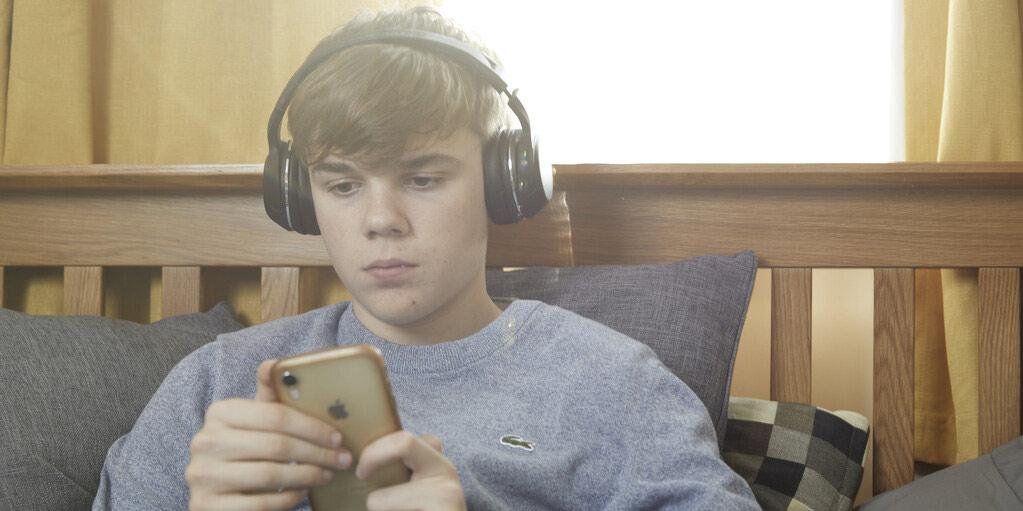 Teenager listening to music in their bedroom